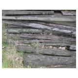 Large pile of weathered wood planks...