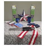Celebrate America!!     BBQ Tongs, 2-Patriotic Flags (13.8 x 23"), Liberty Can Koozie, Liberty Can Koozie Short, Metal Star (12"), 2- Patriotic Flag Wind Blazers (25" x 4.75"), Patriotic Bow (19")