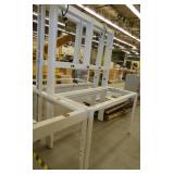 Steel frame, adjustable height workbench with laminate top and wired with electrical outlets 120V plugs