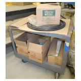 rolling steel cart full of caribou coffee and filters and a box of trash bags