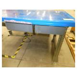 72x36 Workbench with wood top and steel legs, and a couple of drawers, top is covered with a plastic