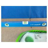 Empire True Blue level, a Milwaukee hole saw kit, and an Irwin Quick-Grip clamp.
