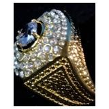Brand New This is a men’s Pinky Ring yellow gold-plated ring featuring a large center stone surrounded by smaller simulated diamonds. Size 7