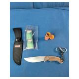 a Coleman 2000015157 fixed-blade knife with a stainless steel blade and wood handle