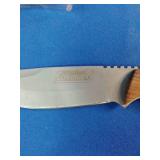 a Coleman 2000015157 fixed-blade knife with a stainless steel blade and wood handle