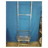 This is a R&B Wire Products commercial laundry cart with a clothes hanging rack.