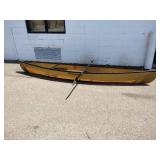 Wenonah Wee Lassie solo canoe featuring a lightweight hull and a kayak-style paddle.