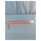 This is a Sven-Saw folding camping saw with a red aluminum handle.
