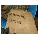 Metal Barrel with Canvas and Feed Sacks with Markings