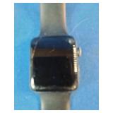 Apple Watch, likely a Series 3 or similar model, featuring a black band.