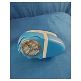 Dritz Jumbo Lint Shaver in blue and white and Brookline Portable Garment Steamer in white.