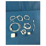 This is a mixed lot of Apple branded white charging cables and power adapters.