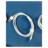This is a mixed lot of Apple branded white charging cables and power adapters.