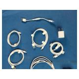 This is a mixed lot of Apple branded white charging cables and power adapters.