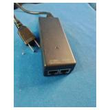 A collection of networking hardware, cables, and power adapters