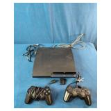 Sony PlayStation 3 Slim console bundle, which includes two black wireless controllers, a power cord, and a video cable
