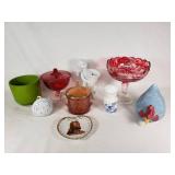 Assorted Glass and Ceramic Home Decor Items including Red Glass Compote, Blue Rooster Figurine, and Heart-Shaped Plate with Religious Image