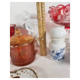 Assorted Glass and Ceramic Home Decor Items including Red Glass Compote, Blue Rooster Figurine, and Heart-Shaped Plate with Religious Image