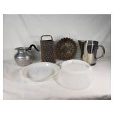 Vintage kitchenware including Glasbake and Tupperware dishes, ABCO aluminum pitcher, Vollrath stainless steel pitcher, and a metal grater with mold pan