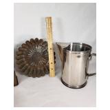 Vintage kitchenware including Glasbake and Tupperware dishes, ABCO aluminum pitcher, Vollrath stainless steel pitcher, and a metal grater with mold pan