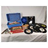 Assorted vintage items including 45 RPM vinyl records, pencils, and tools