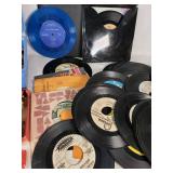 Assorted vintage items including 45 RPM vinyl records, pencils, and tools