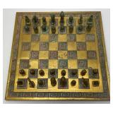 Est. $400.00- $600.00 14" x 14" Vintage Greek Brutalist Bronze Chess Set With Matching Brass Board