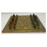 Est. $400.00- $600.00 14" x 14" Vintage Greek Brutalist Bronze Chess Set With Matching Brass Board