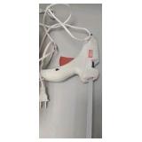 plastic container of glue and glue gun