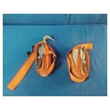 2 Good Year Orange tie-down straps feature heavy-duty metal ratchets for securing cargo. 1100 Pound Rating