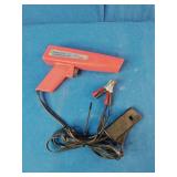 Sunpro Actron CP7504 inductive timing light, used for precise engine timing adjustments.