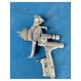 SATAjet 5000 B HVLP spray gun, featuring a compact design with a prominent 1.3mm nozzle and green accent ring.