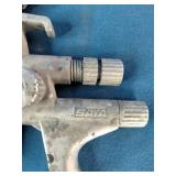 SATAjet 5000 B HVLP spray gun, featuring a compact design with a prominent 1.3mm nozzle and green accent ring.