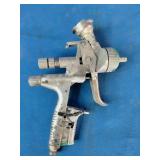SATAjet 5000 B HVLP spray gun, featuring a compact design with a prominent 1.3mm nozzle and green accent ring.