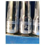 Metric Mac Tools set of deep sockets arranged on a metal storage rail