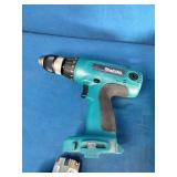 Makita 6337D 14.4V cordless tool set featuring teal-colored drills and a matching charger.