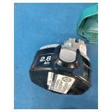 Makita 6337D 14.4V cordless tool set featuring teal-colored drills and a matching charger.