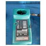Makita 6337D 14.4V cordless tool set featuring teal-colored drills and a matching charger.