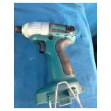 Makita 6337D 14.4V cordless tool set featuring teal-colored drills and a matching charger.