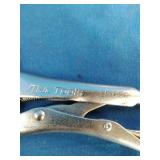Mac Tools brand locking C-clamps used for securing workpieces.
