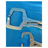 Mac Tools brand locking C-clamps used for securing workpieces.