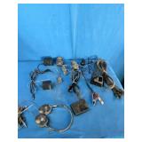 Bulk lot of various electronic accessories, including power adapters, charging cables, and audio/video cables.