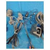 Bulk lot of various electronic accessories, including power adapters, charging cables, and audio/video cables.