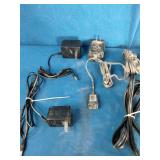 Bulk lot of various electronic accessories, including power adapters, charging cables, and audio/video cables.