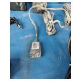 Bulk lot of various electronic accessories, including power adapters, charging cables, and audio/video cables.