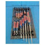 Craftsman acetate-handle screwdrivers mounted on a storage rack organizer.