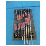 Craftsman acetate-handle screwdrivers mounted on a storage rack organizer.