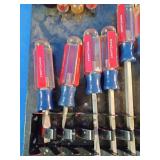 Craftsman acetate-handle screwdrivers mounted on a storage rack organizer.