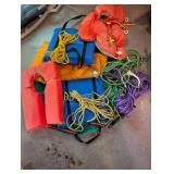 Personal flotation devices and throwable rescue lines