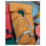 Personal flotation devices and throwable rescue lines